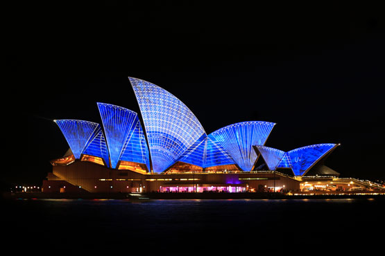 Sydney Opera House lit up in blue