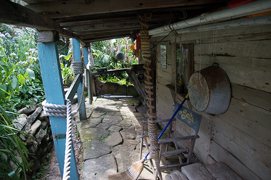 The verandah of this Crater Cove hut boasts an impressive stone floor.