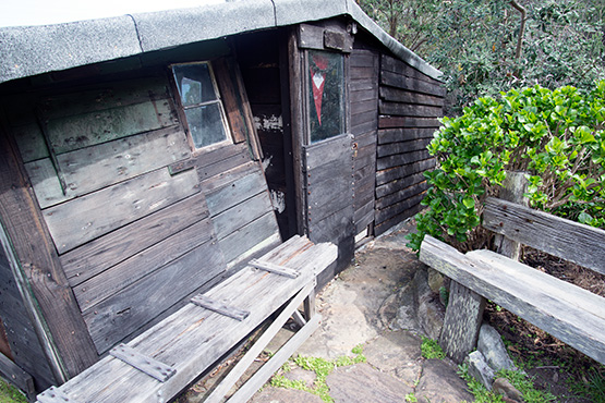 Timber seats outside the entrance to Crater Cove hut, Sydney