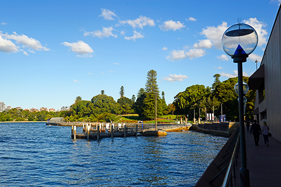 Looking back on the Sydney Royal Botanic Garden from the walkway that runs alonside the Opera House, on Bennelong Point.