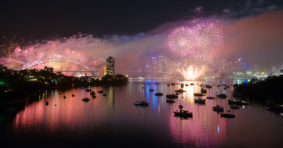Sydney Harbour is clothed in a purple mist by New Year's Eve fireworks