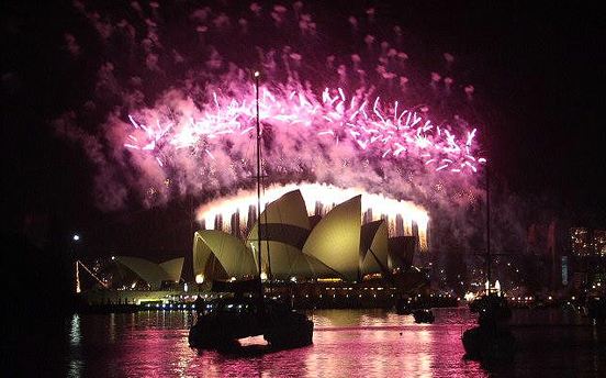 A cloud of pink created by the Sydney Hrbour New Year's Evev fireworks illuminates the Sydney Opera House in 2005