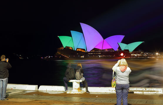 Tourists take photos of the Sydney Opera House during the 2015 Vivid Sydney light festival